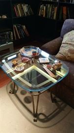 glass and brass side table with various tchotchkes
