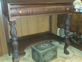 closeup of desk legs - metal Lipton tea box