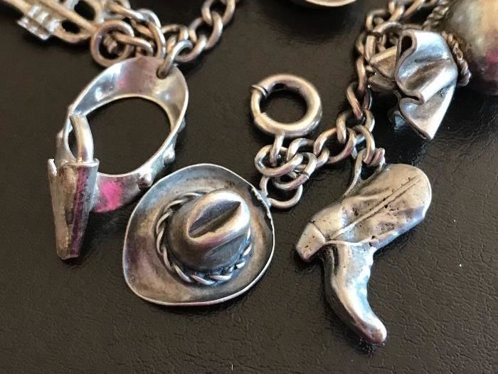 Close up of some of the charms on the vintage charm bracelet 