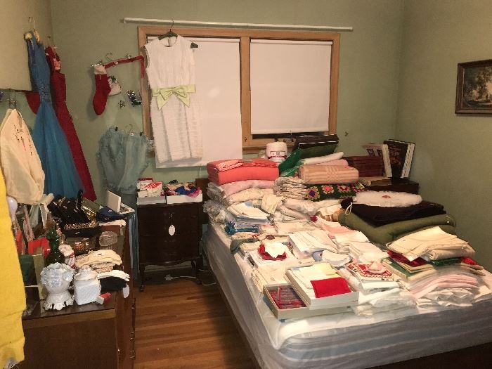 A bedroom full of treasures and good finds! Loads of vintage linens, ladies clothing and more. 