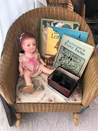 Vintage children’s rocking chair, doll and children’s books. 