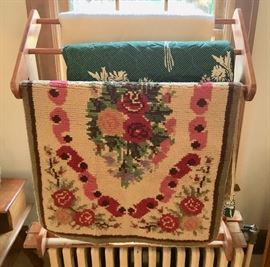 Rugs, bedspreads, blankets and wooden blanket stand