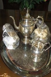 The 4 piece tea set is Gorham STERLING SILVER. The tray underneath is silver plate.