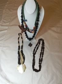 Four native crafts necklaces and a wood and sterling pendant.