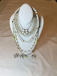 Vintage necklaces, some with matching earrings.
