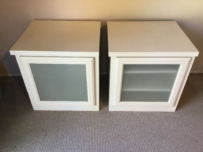 White entertainment center cabinets with glass doors.