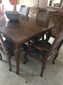 Dining table by BAKER with 6 chairs (2 arm/4 side) and two leaves.  Backs of side chairs are cane