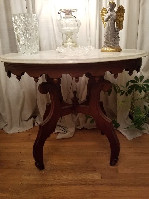 Cherry marble top table with oil lamp that has been electrified.