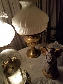 Alladin lamp, seven day clock, kerosene lamp that has been "electrified " with beautiful globe on one of the marble top tables.