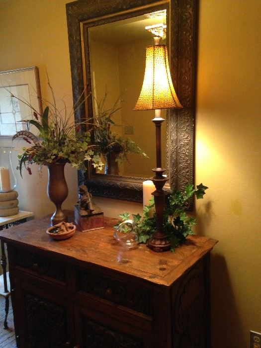 The large mirror, stunning antique chest, and other accents will welcome you in the entry.
