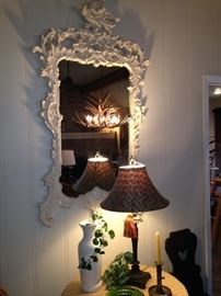 Beautifully carved framed mirror reflects the dinng room (stays-with-the-house) chandelier.