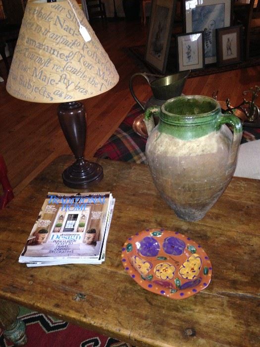 Table lamp, colorful bowl, and primitive jug on antique table