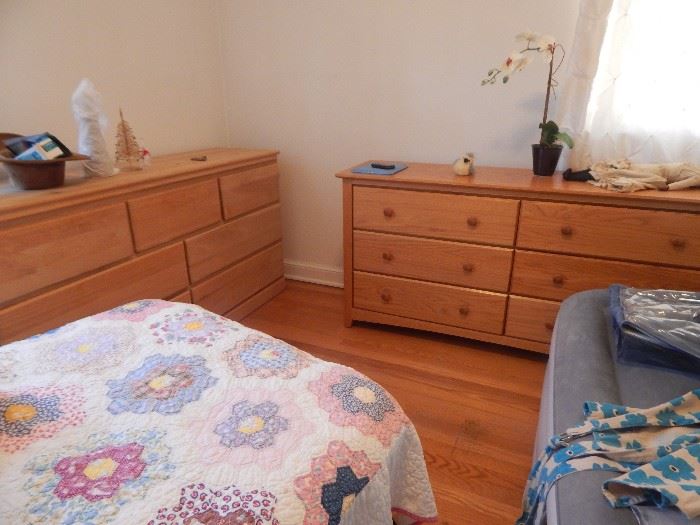 Mid century bedroom light oak bedroom dressers, twin bed, quilts and a blow up stow away bed.