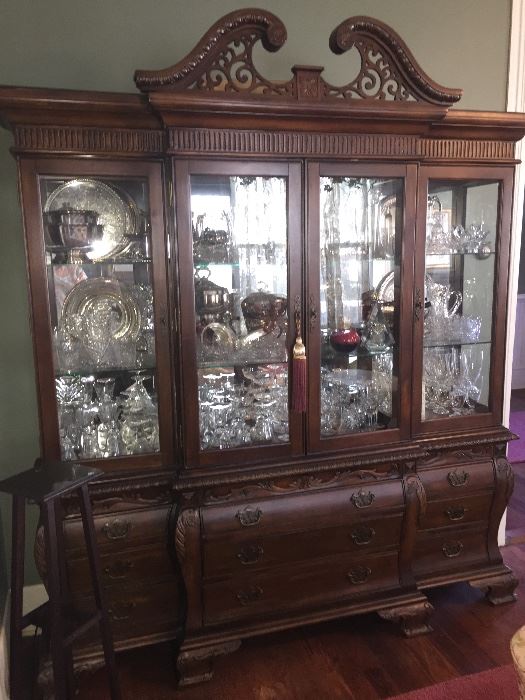 huge china cabinet filled to the top with crystal, china, and silver