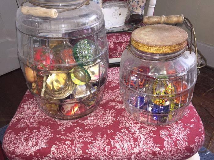two huge pickle jars filled with paper weights