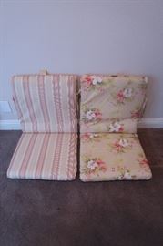 Matching chair cushions, strips on one side, floral pattern on the other.