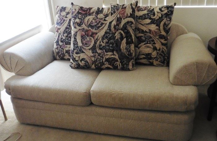 Loveseat with reversible cushions.