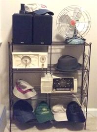 Vintge metal shelf, vintage fan, Boston Acoustics speakers, various hats, mid century clocks