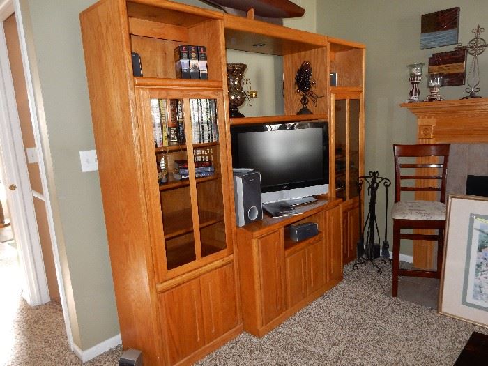 Entertainment unit, oak finish, we have a tv in there, a blue ray, books and decor