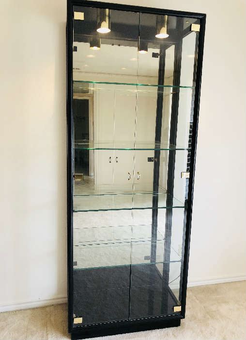 Henredon Furniture. Elegant, black lacquer streamlined design. Beveled glass doors with contemporary/deco style handles. Heavy glass shelves with grooves in the back to hold items. Glass side panels. Illuminated interior. Mirrored back interior. 
Measurements: 84" tall, 32" wide, 15" deep. 
Price $690.00 firm.  Same item sold on ebay for $1350.00