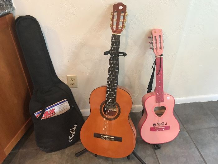 Protege Spanish guitar by Corboda @ $85 (new $189) with case, guitar stand @ $5 and pink Schoenhut guitar @ $28