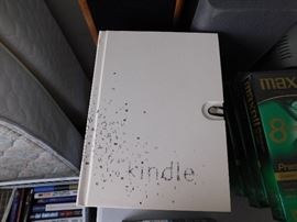 Two kindles in boxes, one unopened and new.