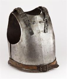 Authentic 18th Century Plate steel European cuirass, constructed of a separate breastplate and backplate, with the latter attached to the former by means of an adjustable leather strap at each shoulder, protected by riveted steel plates, and with an adjustable leather waist belt. The inside of the backplate bears a large numeral “7”, likely an old auction or collector”s accession number. Likely German Armor. The use of the cuirass as a military accoutrement has an extremely long history, from ancient Greek and Roman times all the way through to use by German and French heavy cavalry up to the beginning of World War I. Based on this example’s use of machine-made rivets and buckles, we believe this armor to date from the 18th Century. The steel shows minor surface oxidation overall, with no active rust apparent, and the leather belts shows minor wear but remain supple, else very good. 
Dimensions: 28" x 24" x 19" 