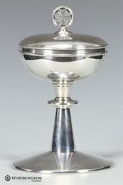 Gorham Sterling Silver Chalice with Lid & Gilt Interior | Beautiful Gorham Sterling Silver Chalice with Lid | The Lid has a cross finial | Chalice & Lid have gold gilt interior | Hallmarked on bottom: “Gorham Sterling ‘lion anchor’, letter ‘G’ and number ‘4539’” | Dimensions: Approx. Base – 9″ H x 6″ W | Total Weight: 19.88 ounces troy | Very Good Condition. 
Dimensions: Approx. 9″ H x 6″ W, Weight: 19.88 ounces troy 