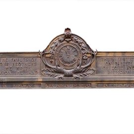 An Elk Lodge memorial plaque. This 4.5’ long metal plaque bears one of the mottos of the Lodge: “The faults of our brothers we write upon the sand; Their virtues on tablets of love and memory”. It bears a central clock emblem with time at the eleventh hour, surrounded by large elk horns. Across the bottom reads “In memorium our absent brothers”.