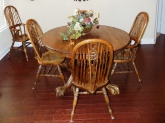 Antique Ball and Claw foot oak table with 6 chairs.  Notice the ornate chairs and claw feet.  Excellent condition.