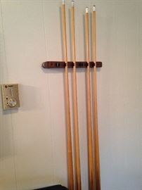 Pool cues mounted in wall rack