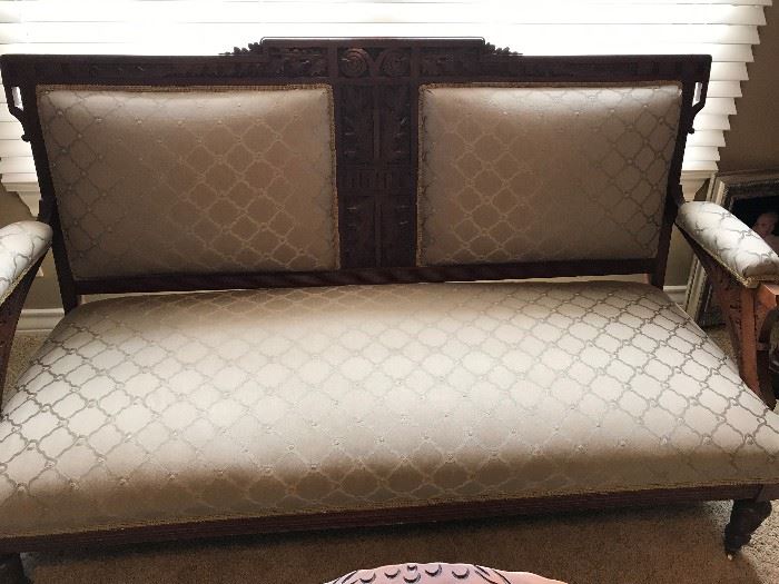 Eastlake antique upholstered settee has matching antique rocker