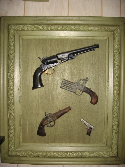 Mounted replica antique pistols.