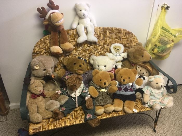 large collection of bears, wicker bench