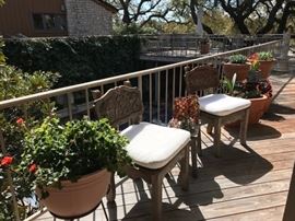 Reed Brothers chairs with pads and potted flowers