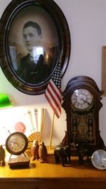 old clocks, photos and carved animals