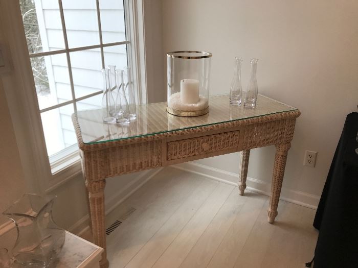 Wicker accent table with custom glass top over the the wicker surface