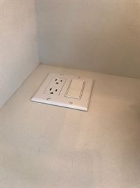 One of the built-in outlets in the white cabinet