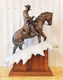 2004 painted bronze sculpture of a cowboy riding a horse up a steep slope in a snow storm, #25/50,entitled "20% Chance Of Flurries", by Christopher J. Navarro (Wyoming, 1956-), 30" x 18" x 9". This is the rare large size maquette of the monumental sculpture created by the artist for Colorado State University, Fort Collins, Colorado, 30" x 18" x 9"