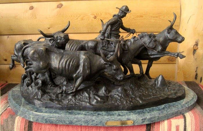 High quality late 20th century solid cast bronze sculpture of a mounted cowboy running with four longhorn cattle, from the 1909 original entitled "Stampede" by Frederic Remington, on a green marble base, 13" x 30" x 13"