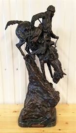 28" high quality late 20th century solid cast bronze sculpture of a mountain man mounted on a horse descending a very steep slope, from the original entitled "Mountain Man" by Frederic Remington, on a green marble base, 28" x 13" x 11"