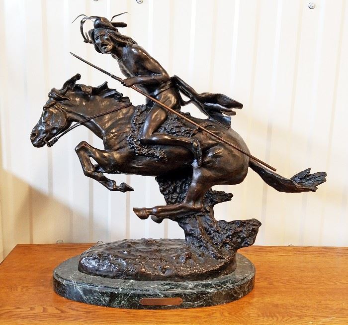 High quality late 20th century solid cast bronze sculpture of a Native American at a gallop with lance and quirt, from the 1901 original entitled "Cheyenne" by Frederic Remington, on a green marble base, 23" x 18 1/2" x 5 1/2"