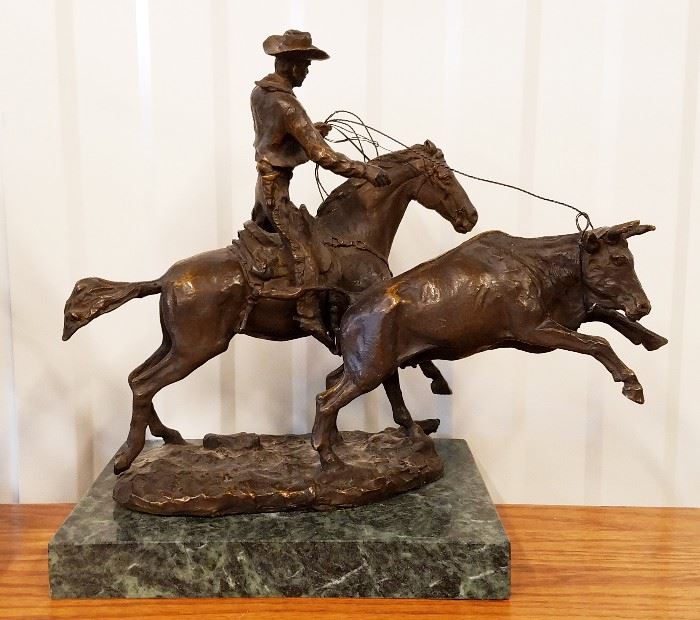 High quality late 20th century solid cast bronze sculpture of a mounted cowboy roping a calf, from the original entitled "Calf Roper" by Charles Russell, on a green marble base, 10" x 13" x 5"