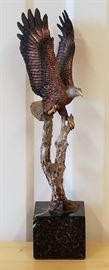 Limited edition mixed media metal sculpture of an eagle with upraised wings on a branch, #347/2500, entitled "Outpost", by Kitty Cantrell (California), issued in 1990 by Legends, 12" x 3" x 3"