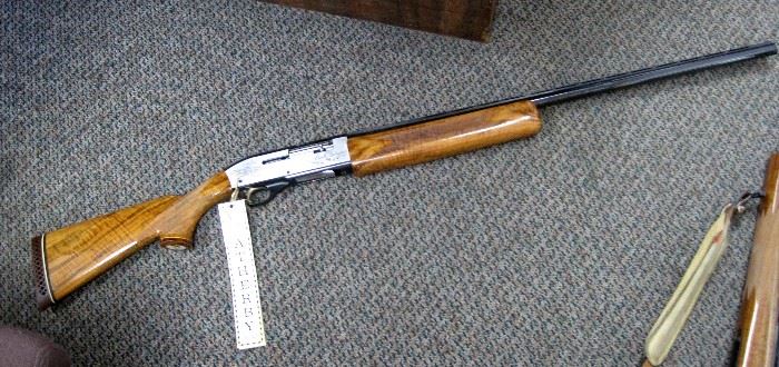 1980 Ducks Unlimited Centurion II shotgun, Weatherby, 12 gauge, 2 3/4" and 3" chamber, slide action, stainless receiver photo engraved with ducks on a marsh, gold plated trigger, checkered wood stock, Serial #80-DU-0100, new with original hang tag. No box or case.