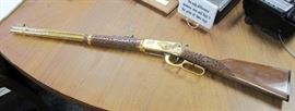 1988 Natrona County Centennial 1888-1988 special limited edition Winchester Model 94AE rifle, lever action, angle eject, 30-30 Win caliber, with gold plated receiver, trigger, barrel and lever, receiver engraved with wagon train scenes by A&A Engraving, Rapid City, South Dakota, laser engraved walnut stock and fore stock, Serial #6140739. There is a dark line on the stock from the zip tie. No box or case