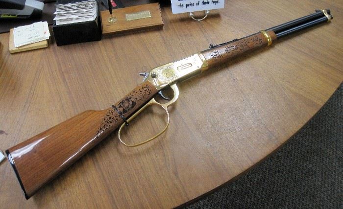 1996 special limited edition, Winchester Model 94AE carbine, 16" barrel, commemorating the Cheyenne Frontier Days Centennial, lever action, angle eject, 45 Colt caliber, with gold plated receiver, trigger, and lever, receiver engraved with rodeo scenes by A&A Engraving, Rapid City, South Dakota, laser engraved walnut stock and fore stock, Serial #6158796. No box or case.