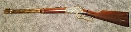 1996 special limited edition, #90/100, Winchester Model 94AE rifle, commemorating the "Daddy Of Em All" Cheyenne Frontier Days Centennial 1897-1997, lever action, angle eject, 30-30 Win, with gold plated receiver, barrel, trigger, and lever, receiver engraved with rodeo scenes by A&A Engraving, Rapid City, South Dakota, laser engraved walnut stock and fore stock, Serial #6078716 . There is a dark line on the stock from the zip tie. No box or case.
