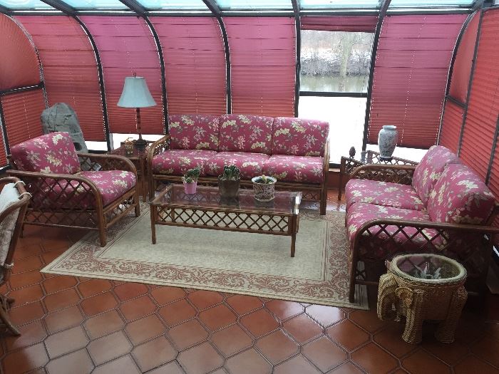 The beautiful solarium has a lovely set of rattan furniture.