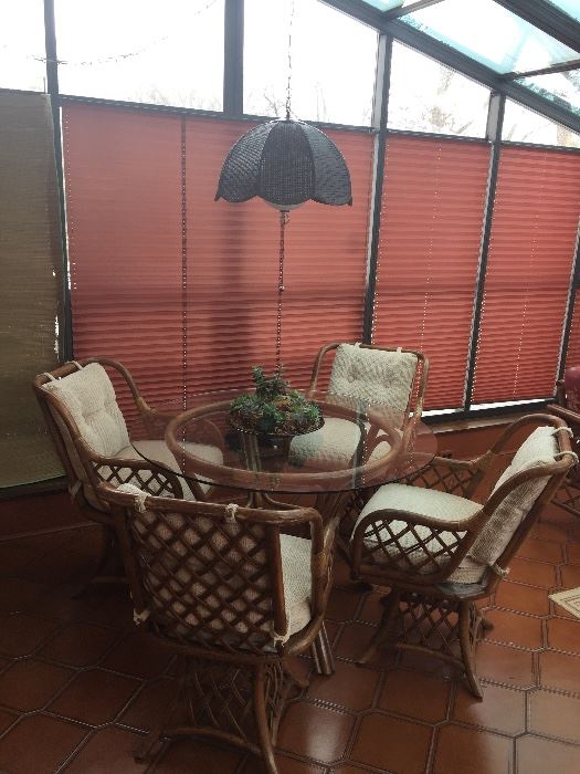 nice rattan glass top table and four chairs - in great shape